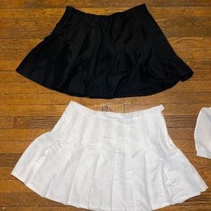 A pair of wild fable pleated mini skirts